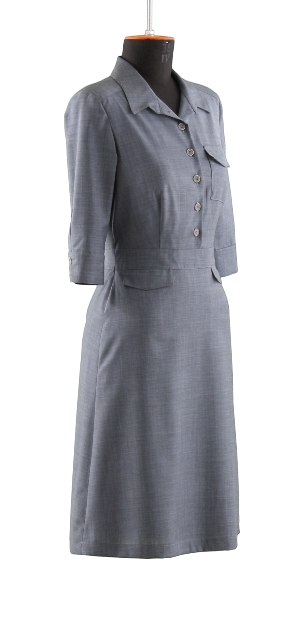 A simple grey, buttoned uniform dress belonging to the women collection with three quarter sleeves in 45 degrees sideways view on a headless mannequin with cutout background.