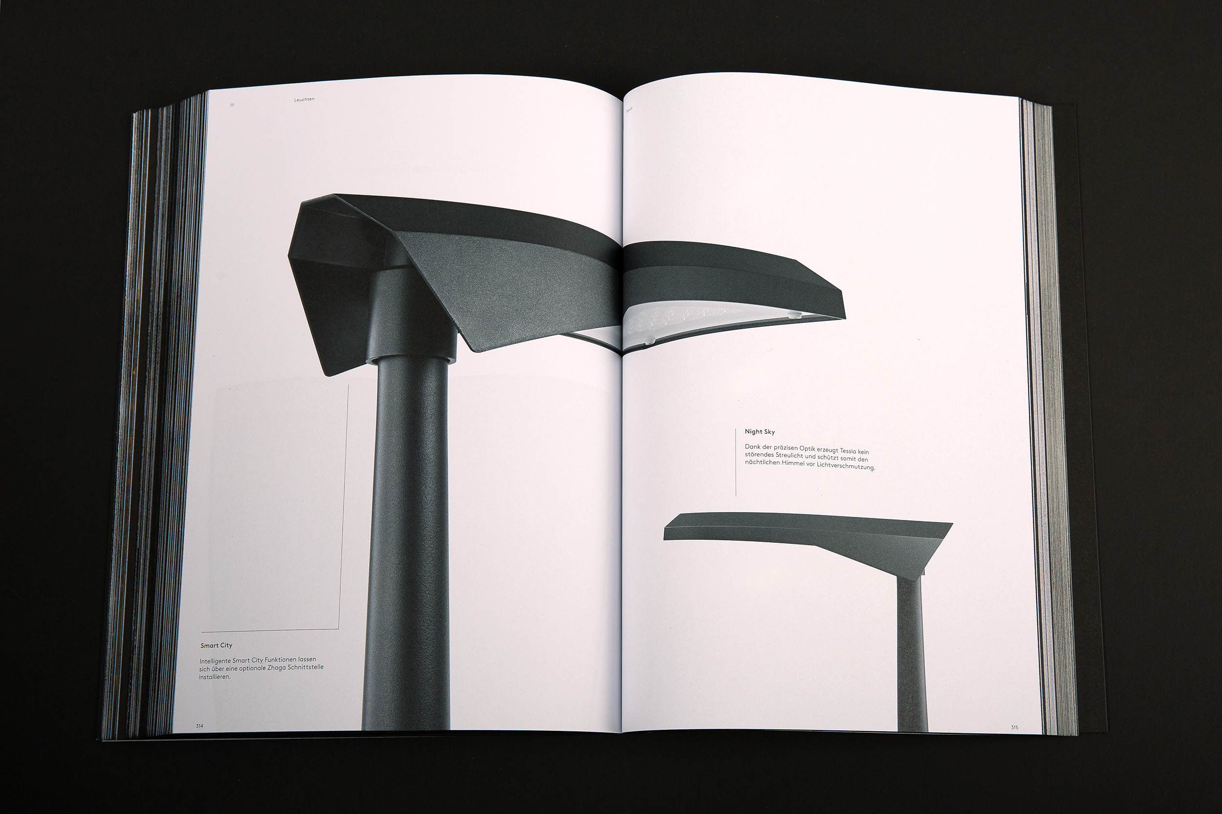 An image of Selux Imagebook, showcasing a double page spread of the Tessia Luminaire with Smart City and Night Sky features against a white background.