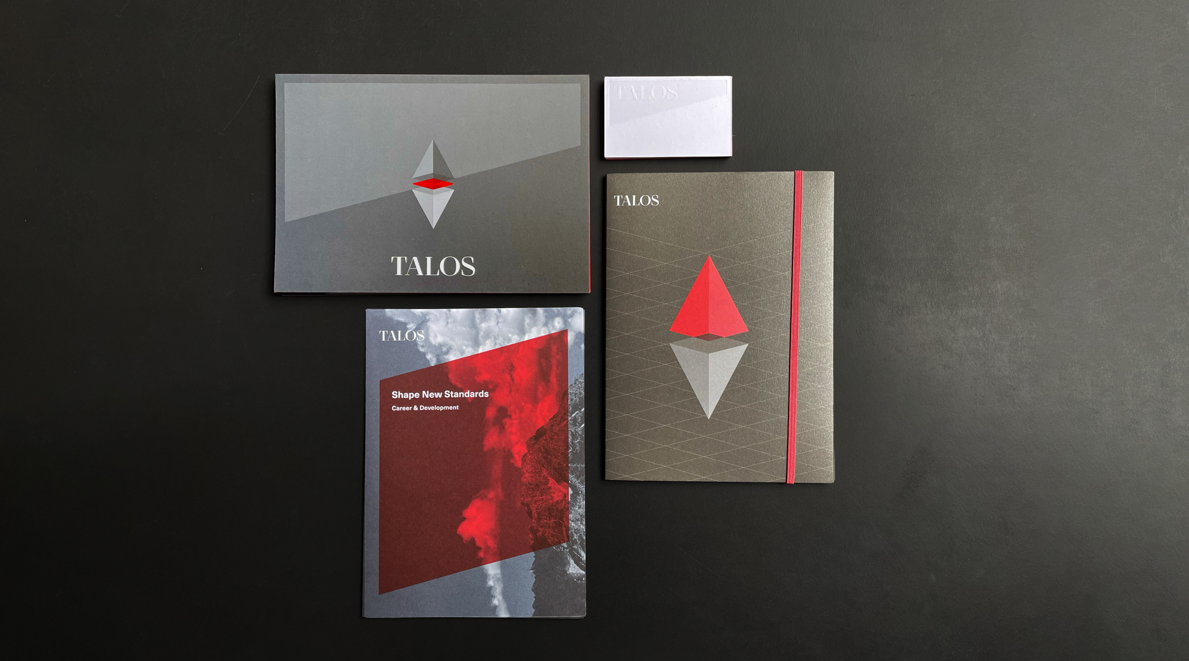 Talos stationary displaing the pyramid keyvisual on an isometric grid. The TALO logotype is custom made.